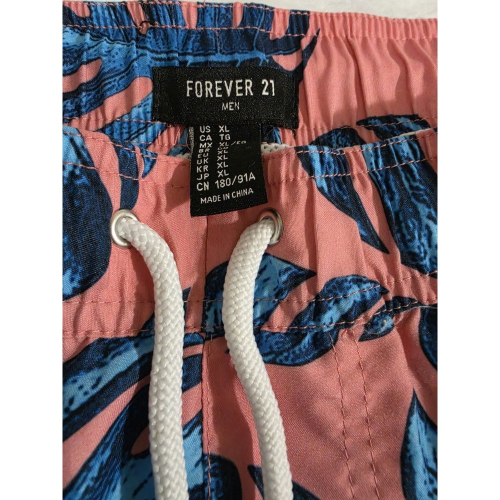 Forever 21 Men's Tropical Print Swim Shorts. These shorts feature a vibrant...